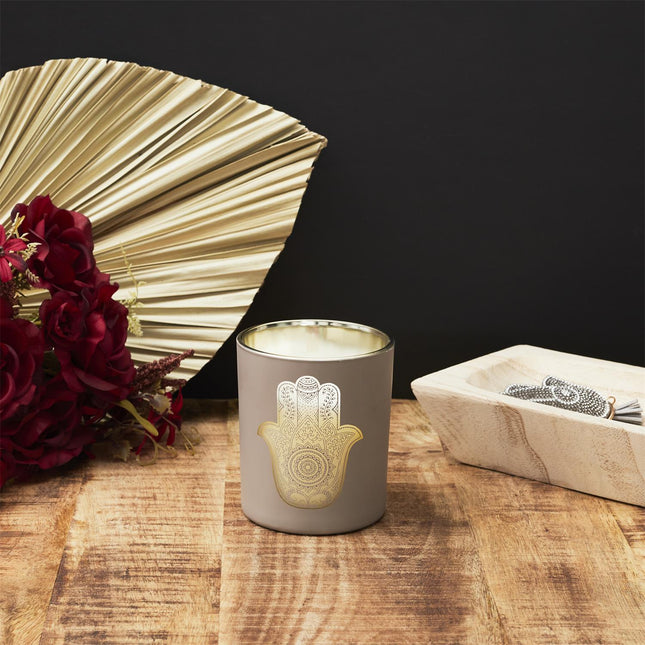 Aromātiskā svece stikla traukā ar zelta Hamsas simbolu
