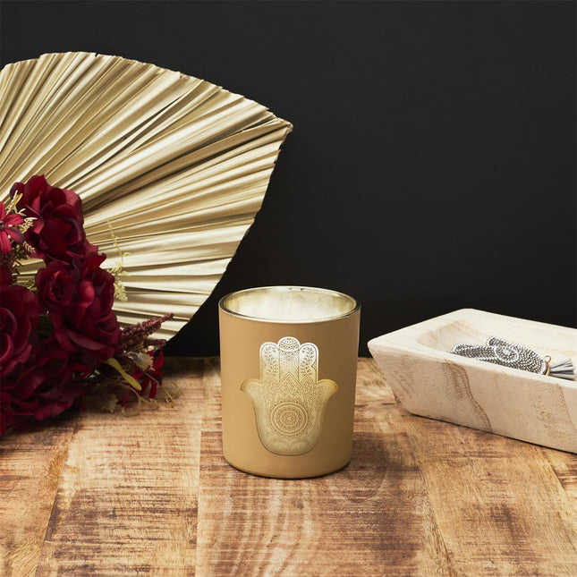 Aromātiskā svece stikla traukā ar zelta Hamsas simbolu