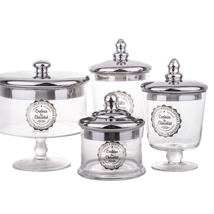 Stikla saldumu trauks uz kājas ar sudraba krāsas vāku